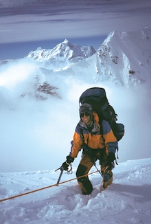 A climber pauses during the physical ascent of the West Rib.