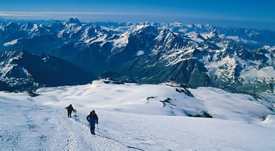 Climbers on Elbrus with the Caucusus behind.
