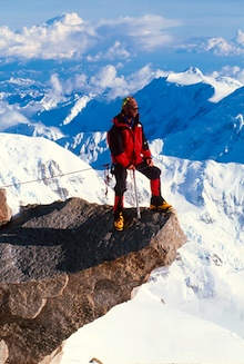 A climber stands on an amazing feature of the West Buttress route, 'The Edge of the World'.