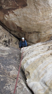 A climber scampers up out of the infamous tunnel on Tunnel Vision (III, 5.7) Jason Martin