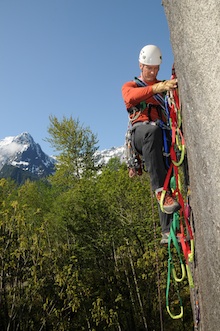 Index - A climber using direct aid to ascend a steep feature in Index, WA.