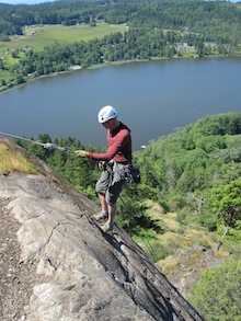 A climber rappels down a cliff-face at Mt. Erie, WA