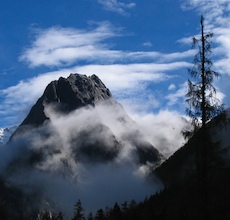 China, Siguniang - Niuxim Shan (Yak Heart Peak) shrouded in morning clouds.