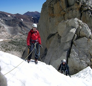 A rope team tops outs on the North Peak Couloir and continues to the summit