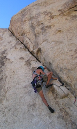 A climber staying focused and moving carefully on lead.
