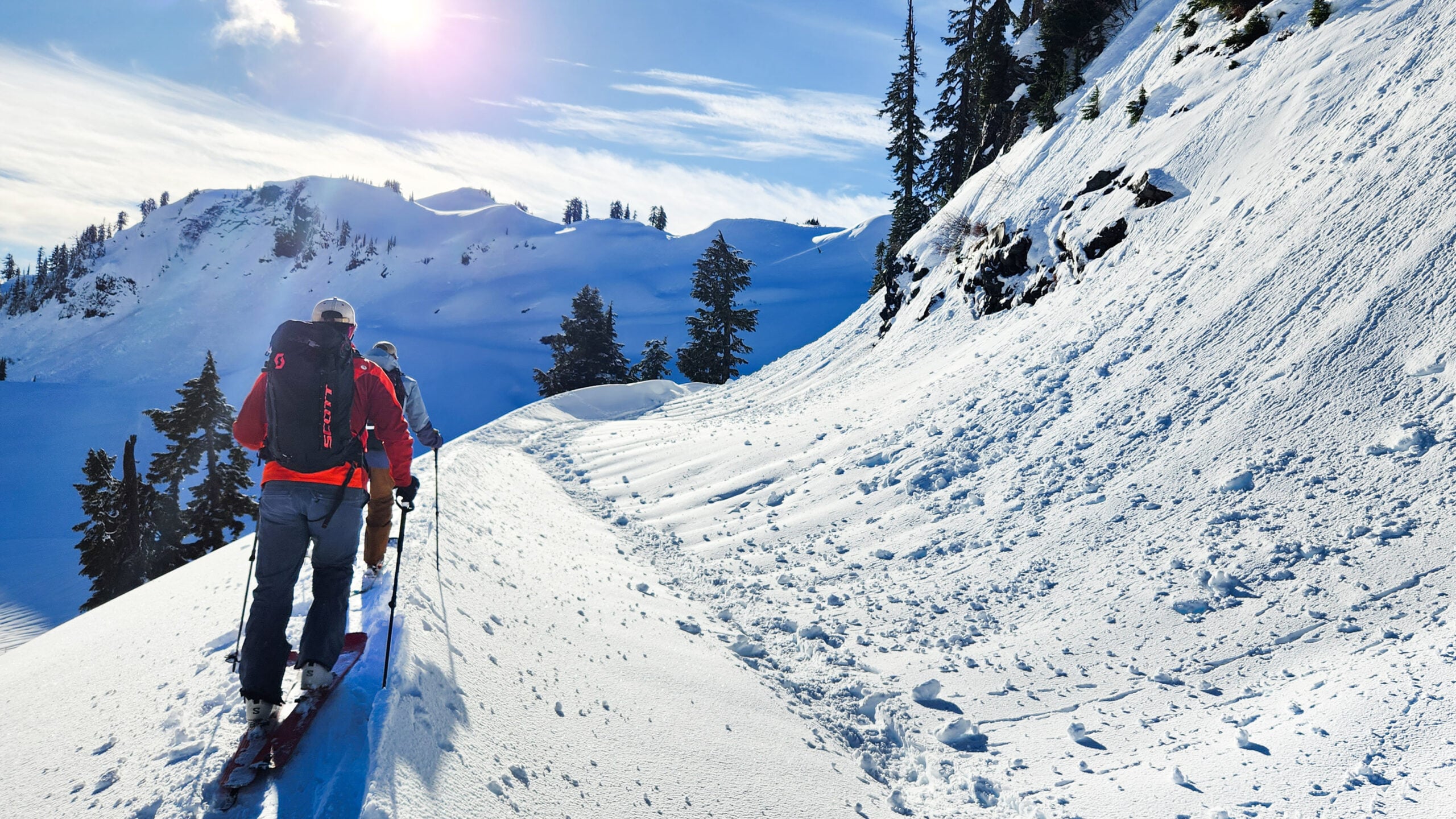 Two skiers tour in the backcountry in the winter mountains