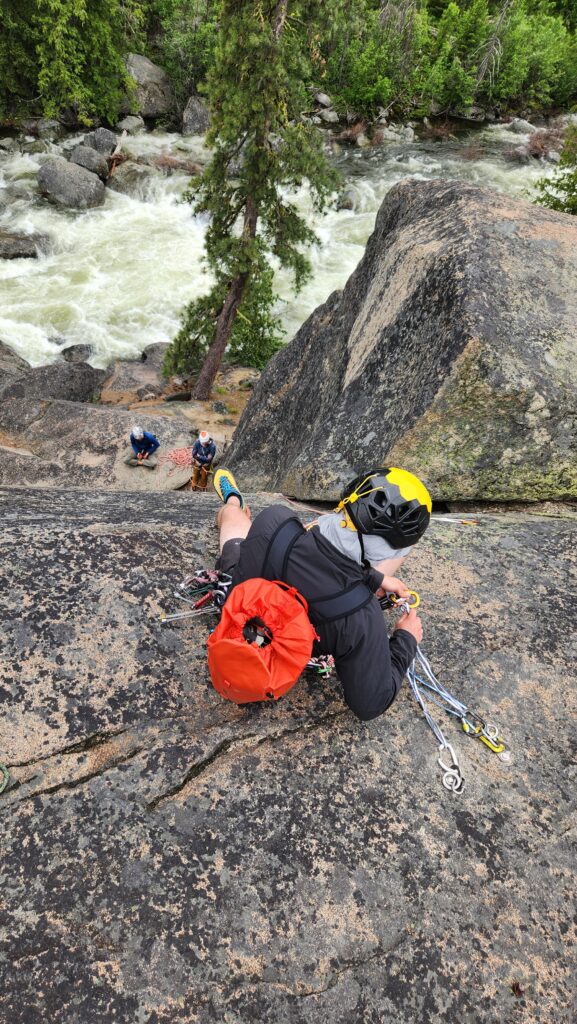A climber belays their partners up a route in Leavenworth, WA during an American Alpine Institute rock climbing course