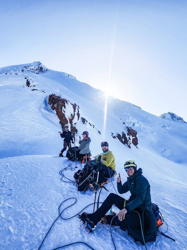 Climbers on a glacier rope team near the summit