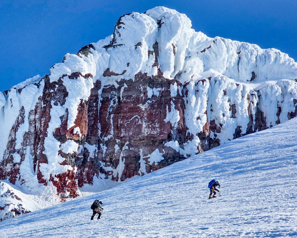 Climbers ascend past rime-covered Baker