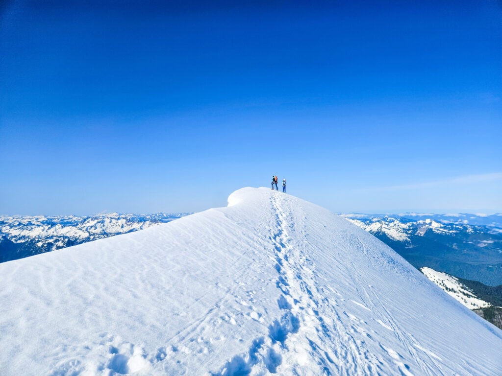 Climbers navigate the narrow summit of Eldorado Peak in Washington's Cascade Pass