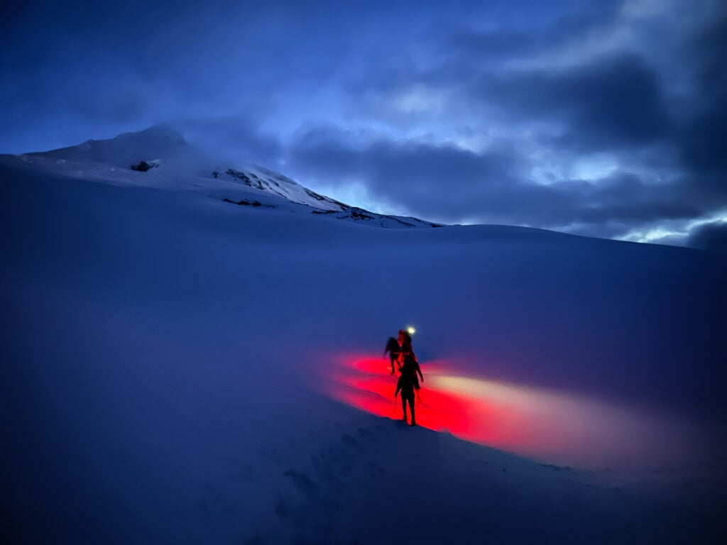 Students with headlamps summiting Mt. Baker.