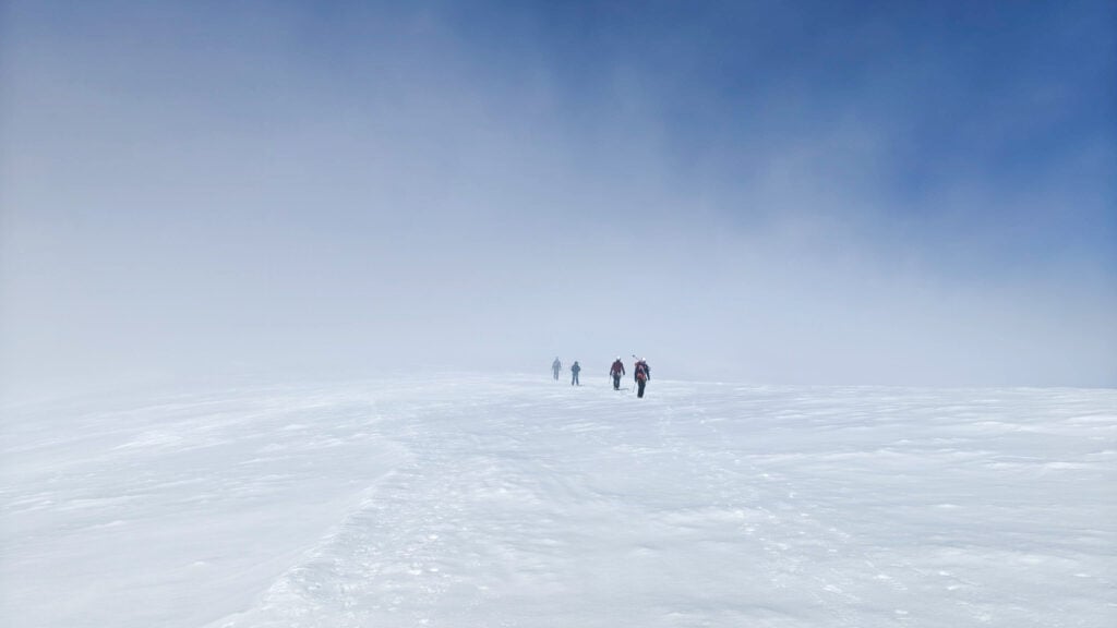 Climbers appear out of the clouds on the summit of Mt. Baker
