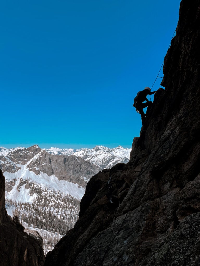 Silhouetted climber on Liberty Bell Beckey Route in Washington Pass