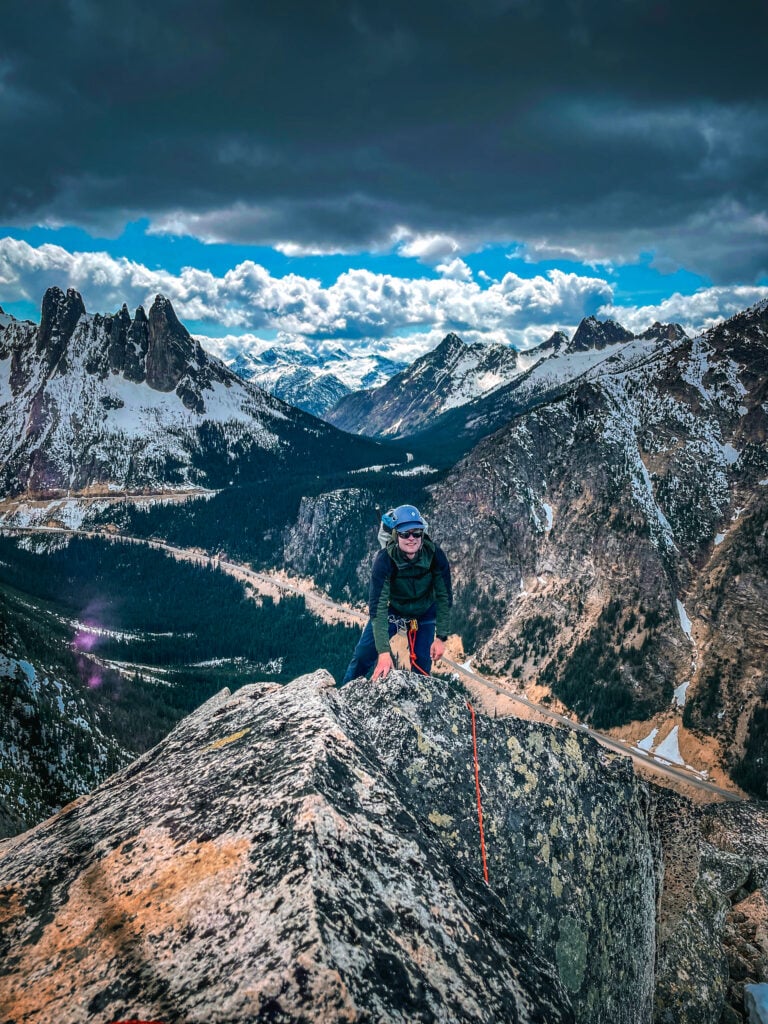 A climber rises over a ridge on Spontaneity Arete in Washington Pass