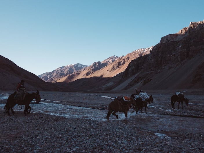 A team crossing the river to camp