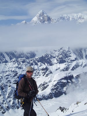 Mount St. Elias towers above guide Ben Traxler.