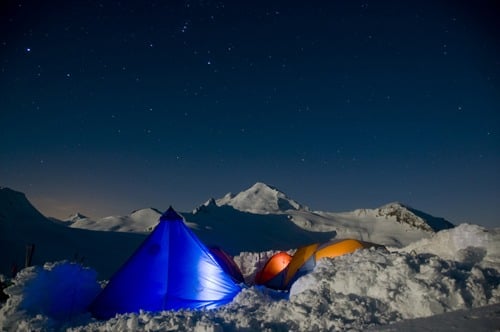 An AAI cook tent under a starry sky