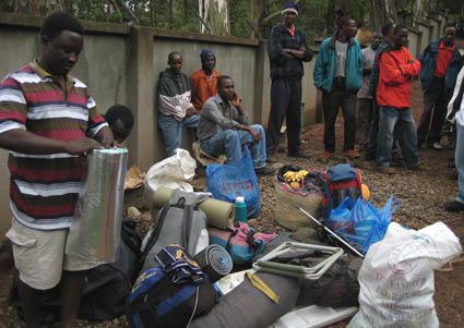 Kilimanjaro Porter Godfrey and staff packing for expedition