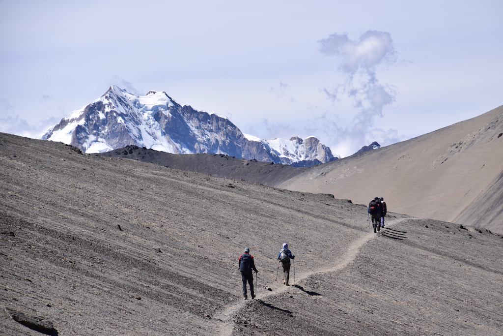 Hikers Traverse the Altiplano with a view of Huayna Potosi