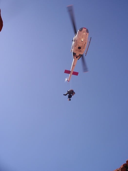 A rescuer is lowered into an accident site in Red Rock Canyon on an American Alpine Institute rope rescue course