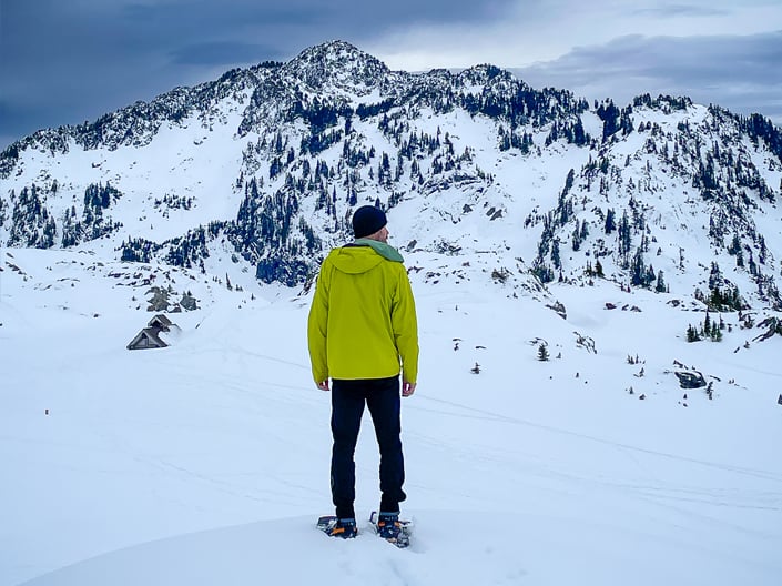 Snowshoer pausing to admire the view of Mt. Herman