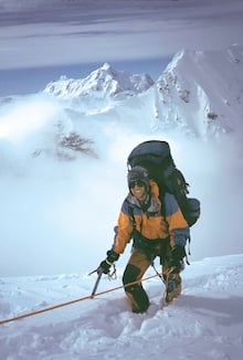 A climber pauses during the physical ascent of the West Rib.