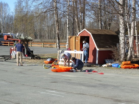 Climbers sort gear on the airstrip in preparation for their flight onto the glacier.