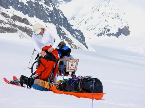 Lower Kahiltna Glacier 10 A climber battles with a mountain of gear on the lower Kahiltna.