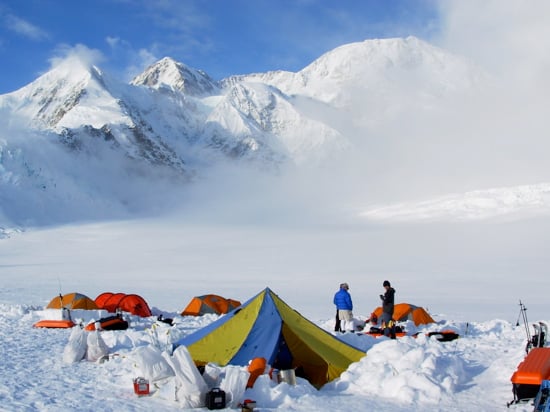 An AAI group at Camp 1 with the West Buttress Route in the distance.