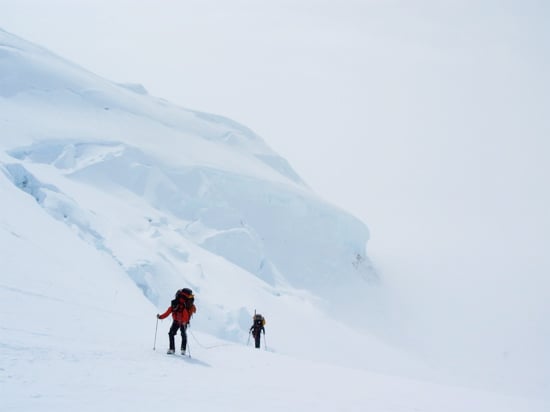 Climbers approach the top of the hill.