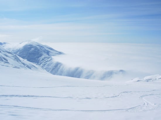 Clouds pouring over Kahiltna Pass from the top of Motorcycle Hill.