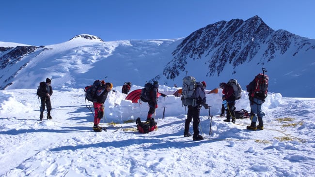 An AAI team gearing up at high camp on their summit day.