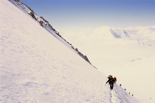 Climbers on the headwall (The Autobahn) with High Camp below.