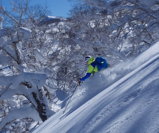 A skier flows through steep and deep powder in Japan.