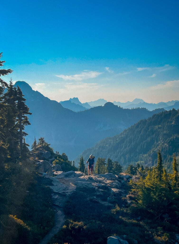 A backpacker makes there way in the backcountry surrounded by the Cascade Mountains of WA