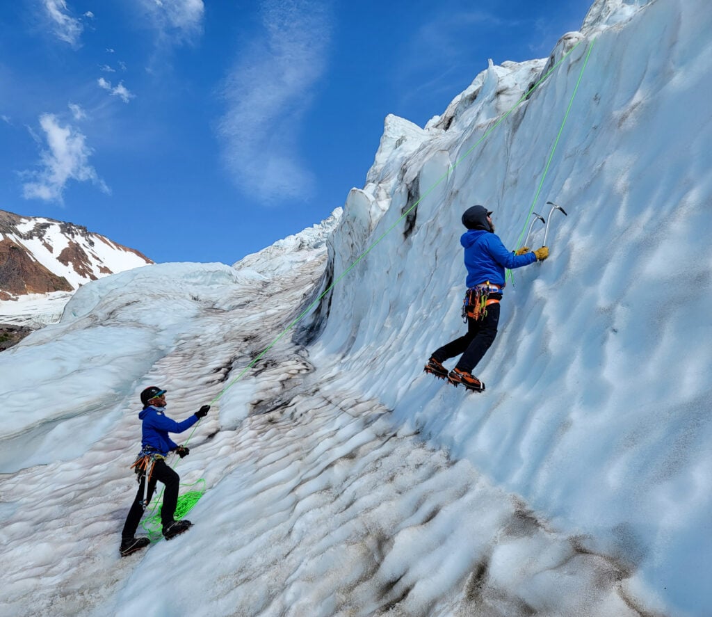 A student learns the basics of alpine ice climbing in the seracs of the north side of Mt. Baker on an American Alpine Institute ice climbing program