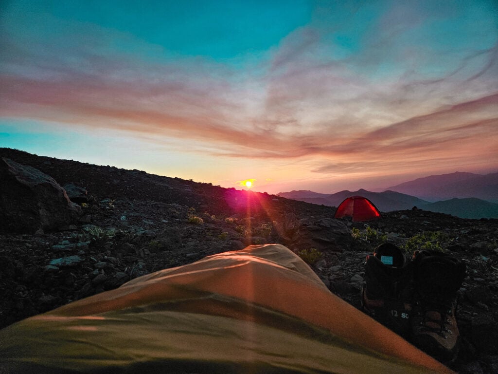 A camper's eye view of an open air bivy during sunset. A perfect way to sleep while backpacking.