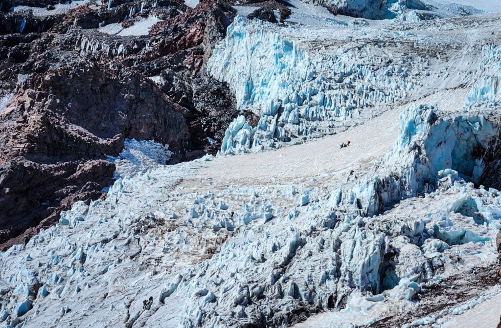 Climbing teams, barely visible amongst the huge seracs and glacier on Mt. Baker's North Side.