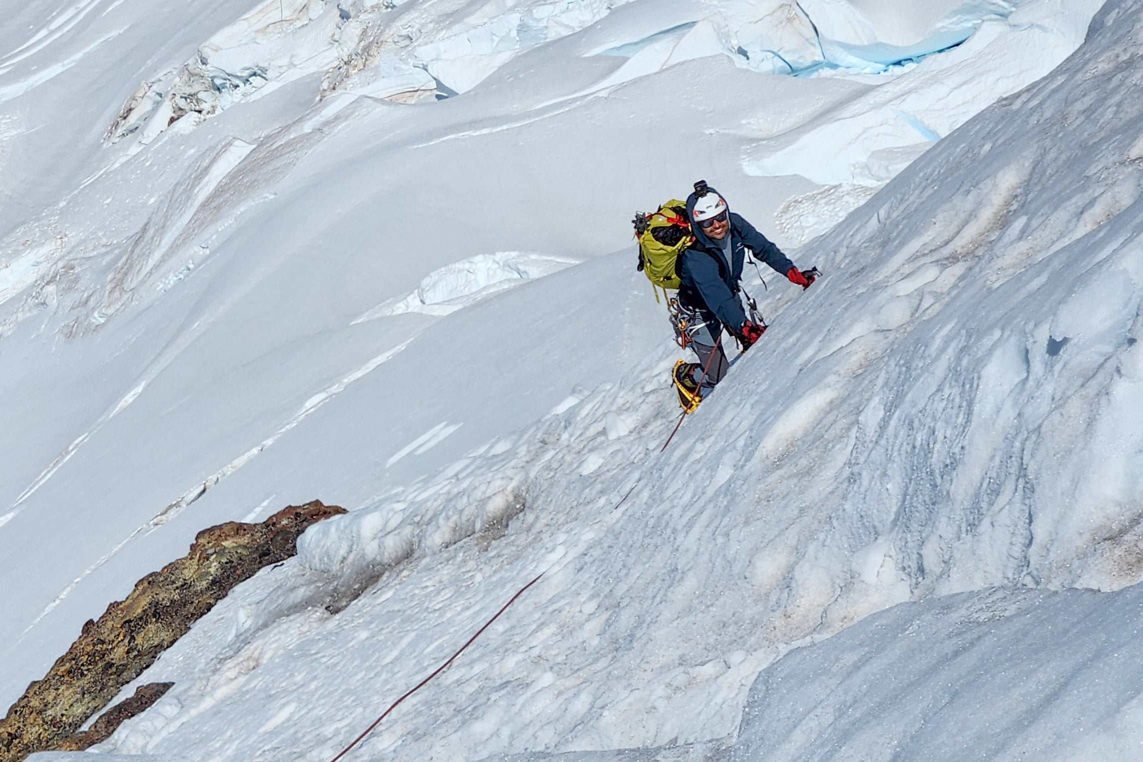 A climber follows while ice climbing the North Ridge of Mt. Baker