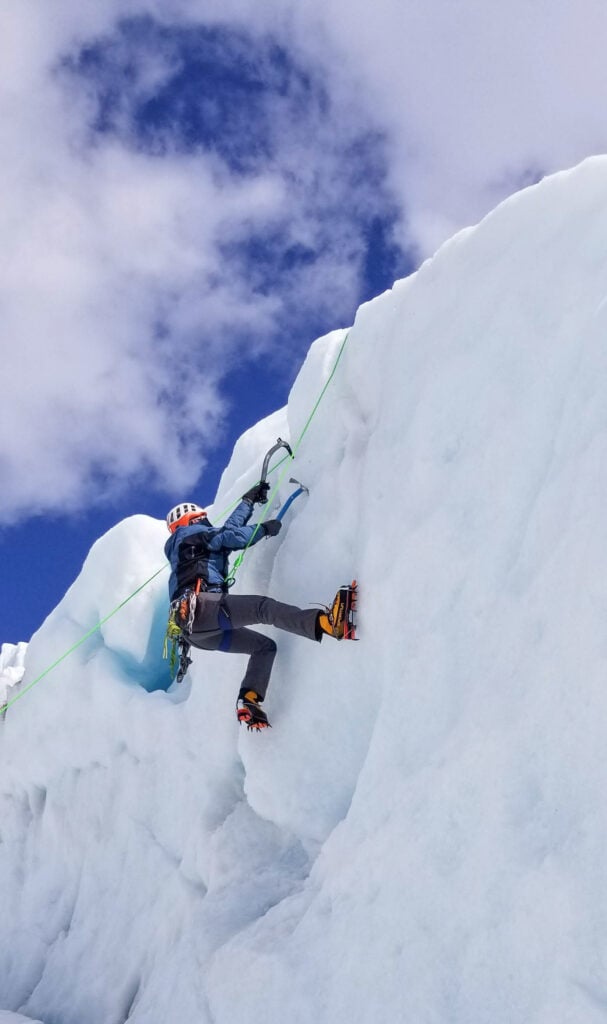 A climber nears the top of a serac while ice climbing on Mt. Baker during an American Alpine Institute ice climbing program