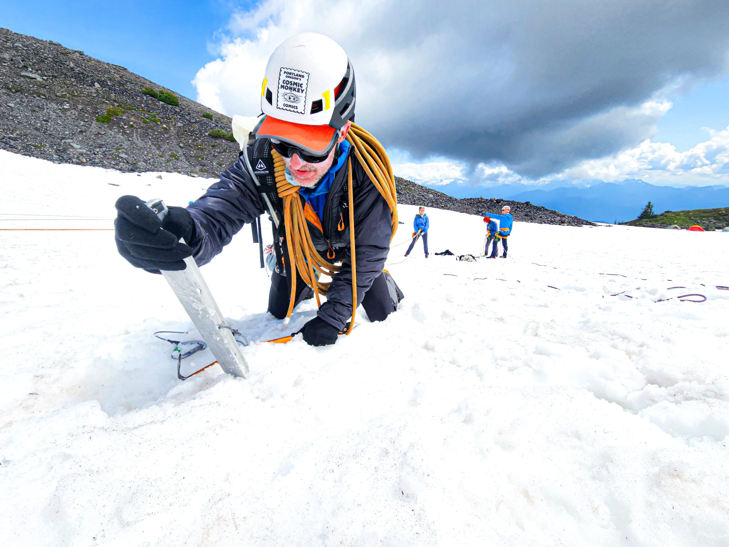 dispatch-card-bg A climbing student places a picket in the glacier of Mt. Baker while setting up a crevasse rescue system during an American Alpine Institute mountaineering program