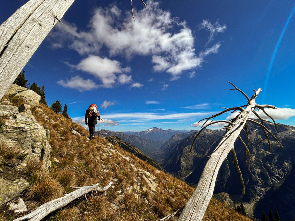 A climber hikes to the next basecamp for the night in the remote alpine wilderness of the North Cascades during American Alpine Institute Alpine Mountaineering and Technical Leadership Part 4 (AMTL4)