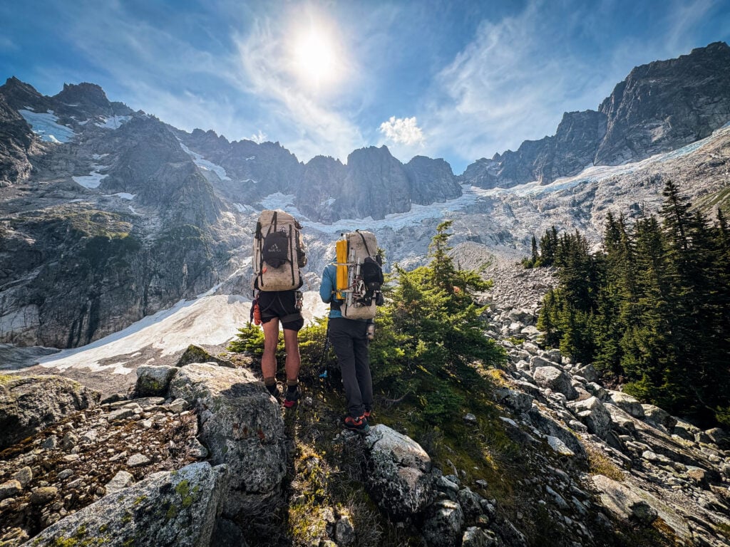 Climbers approach a mountain basin where they will establish camp for the night in the remote alpine wilderness of the North Cascades during American Alpine Institute Alpine Mountaineering and Technical Leadership Part 4 (AMTL4)