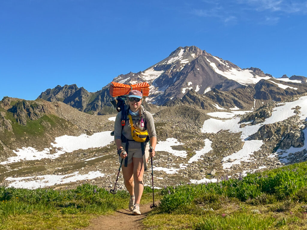 A climber hikes out of the wilderness after successful summit of Glacier Peak during an American Alpine Institute mountaineering program