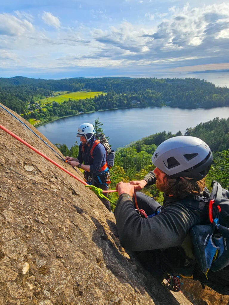 Students learn rock climbing knots and movement at Mt. Erie above the Puget Sound of Washington on an American Alpine Institute rock climbing course