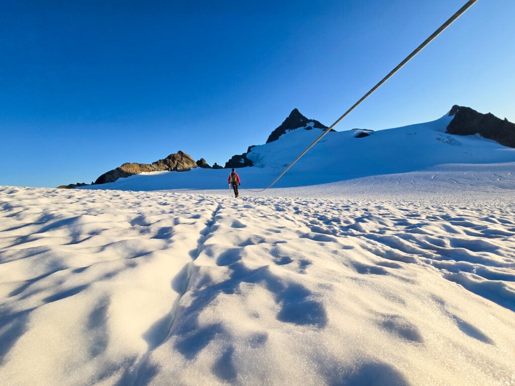 A climber leads the way to the summit across the Sulphide Glacier on Mt. Shuksan on an American Alpine Institute mountaineering course