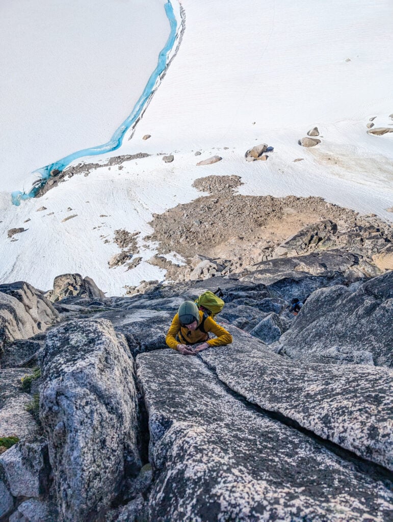 A climbing student places gear while leading a multi-pitch rock climb on their American Alpine Institute AMTL 3 program