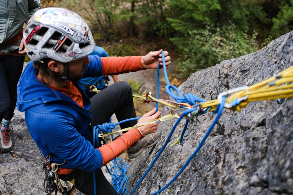 A climber manages the belay station at the anchor of a multi-pitch alpine climbing route on American Alpine Institute's AMTL 3 program.