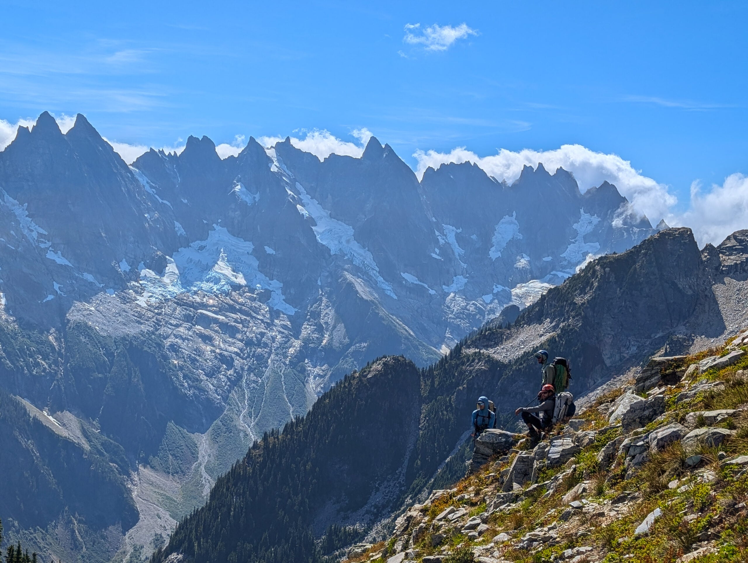 A team rests during their expedition in the remote alpine wilderness of the North Cascades during American Alpine Institute Alpine Mountaineering and Technical Leadership Part 4 (AMTL4)