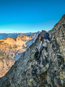Mountaineering Instructor Professional Training Program 2 Climbers navigate a section of rock in the remote alpine wilderness of the North Cascades during American Alpine Institute Alpine Mountaineering and Technical Leadership Part 4 (AMTL4)